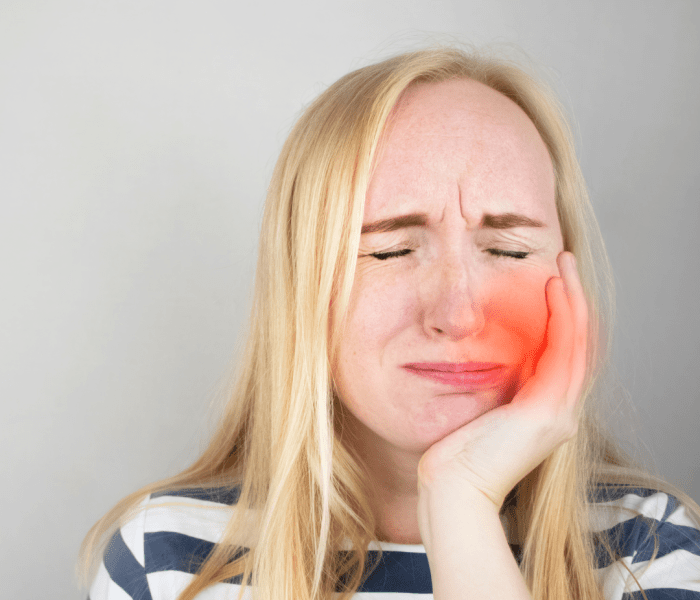 Dental emergency - woman has toothache and pain
